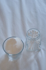 Bamboo cotton buds and cotton pads in bathroom. Biodegradable ear plugs. Eco product