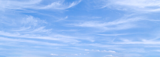 Blue sky with wispy clouds. Panoramic sky background.