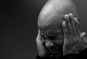 suffering from deafness and hearing loss on grey black background with people stock image stock...