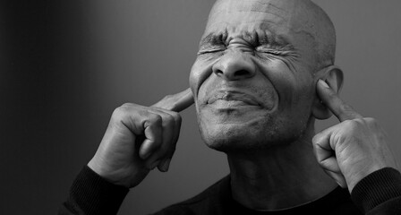 suffering from deafness and hearing loss on grey black background with people stock image stock...