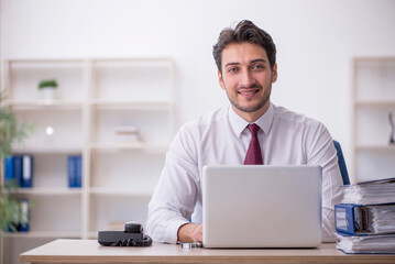 Young male employee working in the office