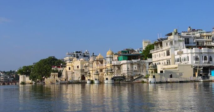 Exterior view of 400 year old historic City palace and other historic buildings along Lake Pichola in Udaipur city, Rajasthan, India