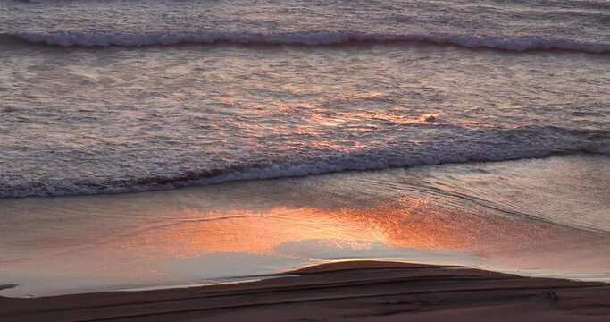 Slow moving ocean waves along the Pacific coast in Orgon during sunset.
