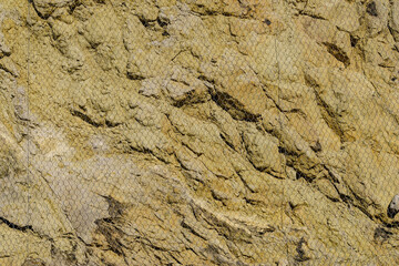 Stone wall with steel protection net