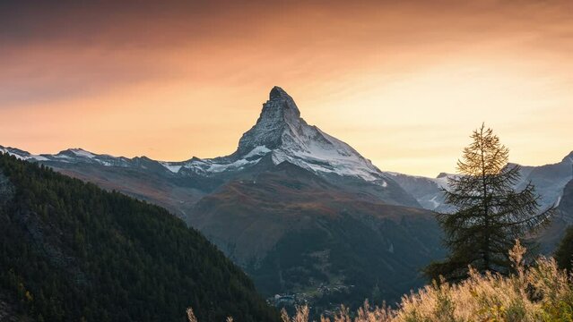 Golden sunset over Matterhorn, Iconic mountain peak and meadow in rural scene at Zermatt, Switzerland