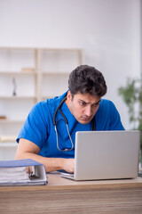 Fototapeta premium Young male doctor in telemedicine concept
