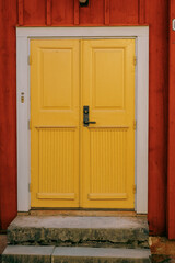 An artsy old yellow wooden door