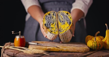 Homemade crusty sourdough bread oven baked and woman baker with autumn seasonal foods in kitchen video - Powered by Adobe
