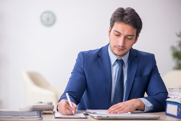 Young male employee working in the office