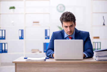 Young male employee working in the office