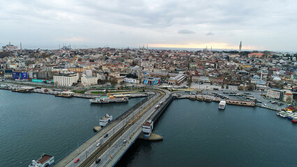 Fototapeta na wymiar aerial view of Galata Bridge overlooking Bosphorus and city. Movement of cars, boats and ships. Istanbul, Turkey. 