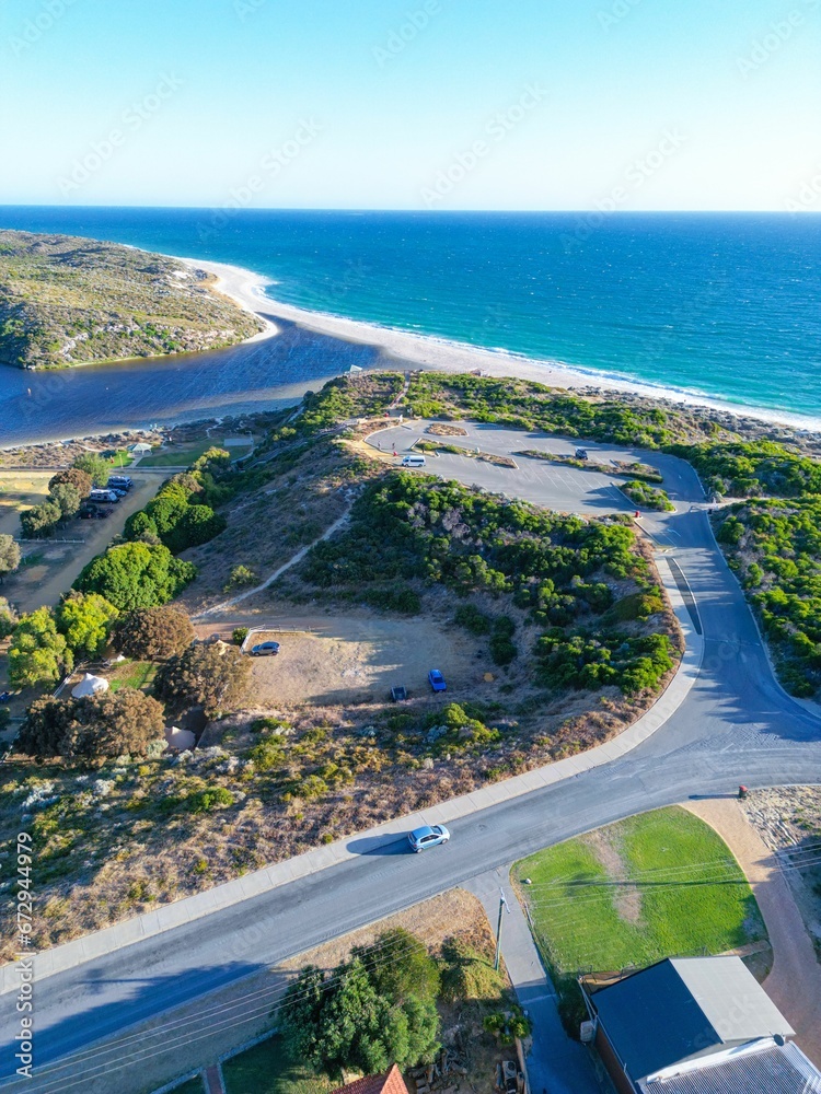 Poster an aerial view of a road near the ocean and an rv park