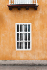 Fototapeta na wymiar colonial window and balcony in white wood, colorful and beautiful colonial house in the city of cartagena de indias colombia