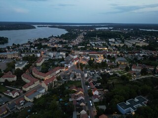 Fototapeta premium Aerial view of residential houses along a river at twilight