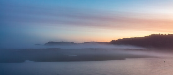 Sandy Beach on West Coast of Pacific Ocean. Foggy Colorful Sunrise.