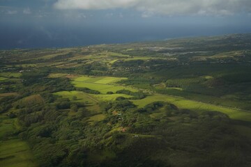 Obraz premium Aerial view of greenery under a cloudy sky on a gloomy day in Hawaii
