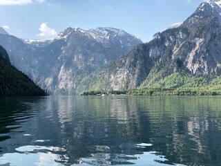 Tranquil landscape featuring Konigssee lake with still waters surrounded by majestic mountains