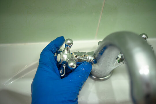 The breakdown of the water tap in the bathroom.Plumbing repairs. A broken faucet.
