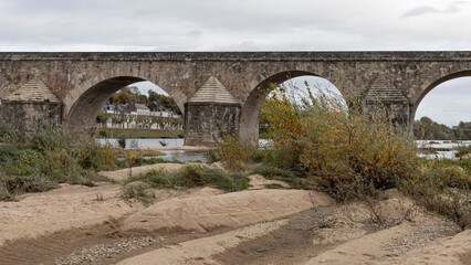 The river bed of the Loire exposing the bridge as the water is low