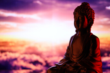 Buddha Purnima and Vesak day concept, Buddha statue with low key light against beautiful and...