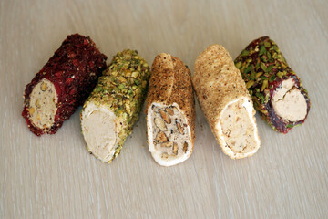Rolls of turkish delight with many different flavors and fillings close up on table of vendors...