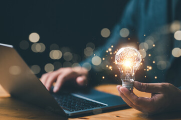 New idea innovation concept, man holding Light bulbs with Brain inside and digital connection line...