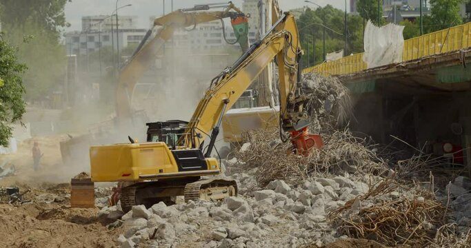 Footage of buildings demolition machinery working in site