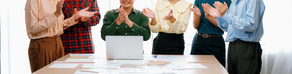 A portrait of Happy professional business team clap their hands to celebrate successful business...