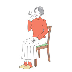 椅子に腰掛け微笑む上品なシニア女性
