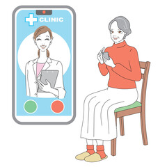 スマートフォンでオンライン診療を受けるシニア女性