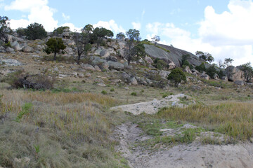 Rocky outcrop mountain with trees and grass on the Mount Mackenzie Tourist Drive near Tenterfield in New South Wales, Australia