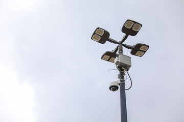 surveillance camera on a city street, symbolizing security and monitoring, framed against an urban...