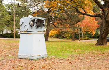 surveillance camera on a city street, symbolizing security and monitoring, framed against an urban backdrop with a neutral tone
