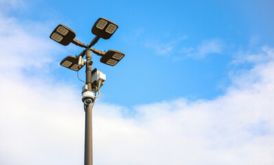 surveillance camera on a city street, symbolizing security and monitoring, framed against an urban backdrop with a neutral tone