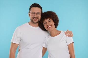 Fototapeta premium International dating. Portrait of happy couple on light blue background