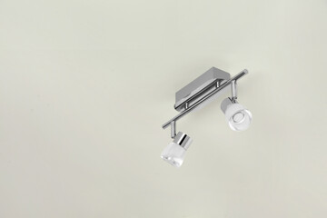 Stylish light fixture on ceiling indoors, low angle view