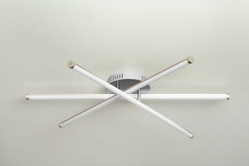 Stylish light fixture on ceiling indoors, low angle view
