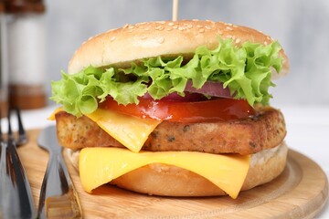 Delicious burger with tofu and fresh vegetables served on table, closeup