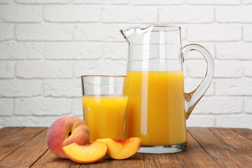 Delicious peach juice and fresh fruits on wooden table