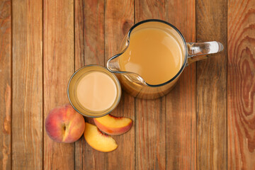 Delicious peach juice and fresh fruits on wooden table, flat lay