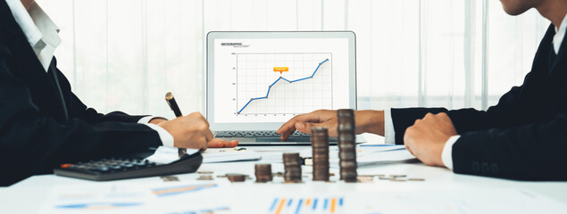 Business intelligence analyst use BI software on laptop to analyze financial data dashboard with...