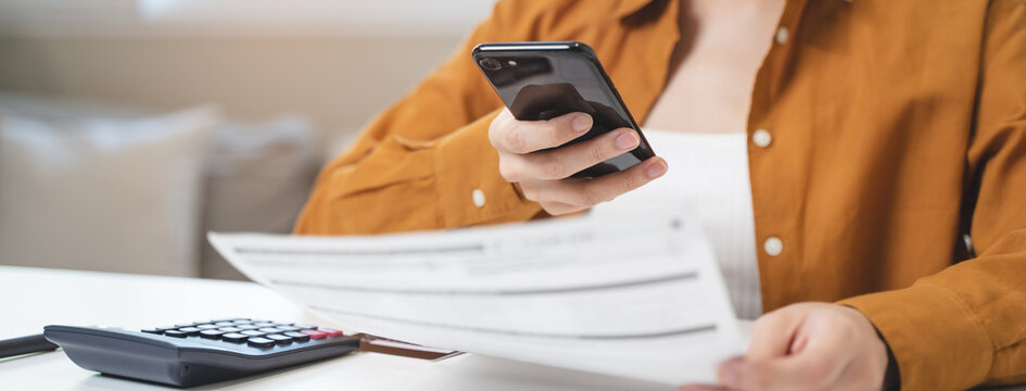 hands of woman using mobile smart phone for scan and payment bill online