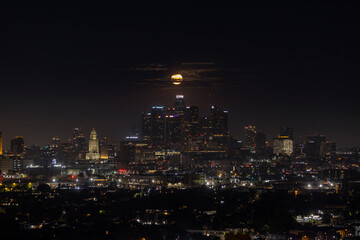 The full moon setting behind downtown Los Angeles
