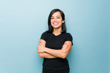 Cheerful woman smiling looking happy in a blue background