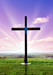 christian cross at sunset or sunrise