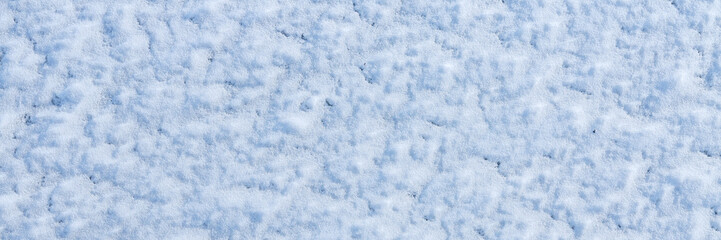 Natural snow texture. The surface of clean fresh snow. Snowy ground. Winter background with snow patterns. Perfect for Christmas and New Year design. Closeup top view.