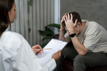 Stressed and depressed patient seeking help from psychiatrist with mental illness and depression in...
