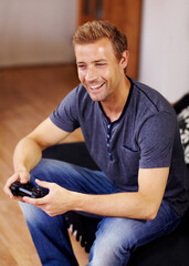 Man, video game and home on sofa, controller or smile for online competition, relax or press in lounge. Gamer person, playing and idea with click for strategy, streaming or digital challenge on couch