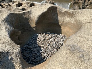 The view of the water in the dam during the dry season with its rocks is very beautiful