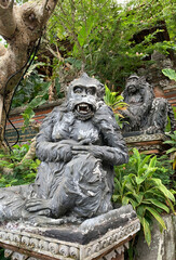 Stone monkeys statues in sacred monkey forest. Old decorative monkey sculptures in Bali ubud sacred...